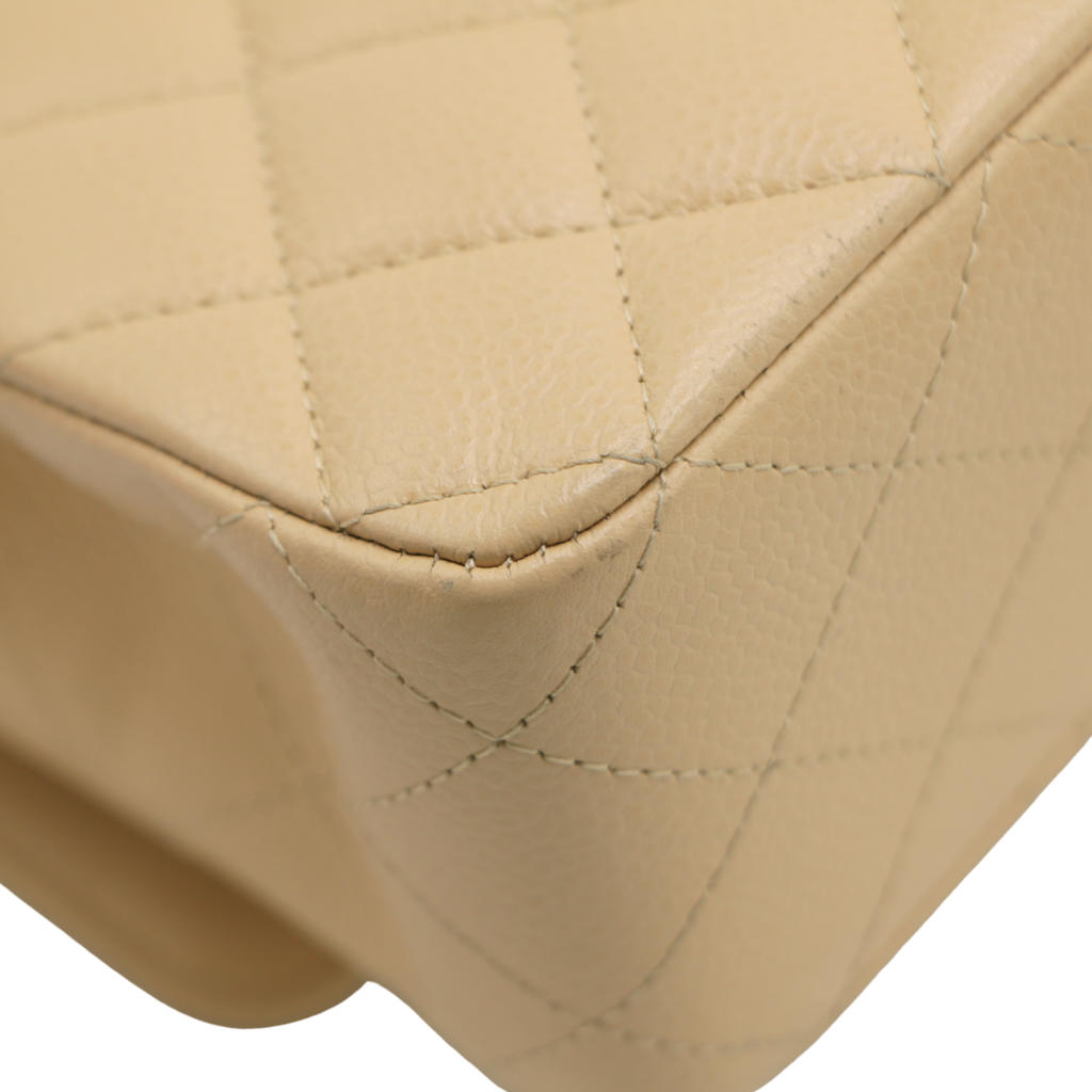 Chanel Medium Classic Double Flap bag crafted from caviar leather with beige gold-tone hardware