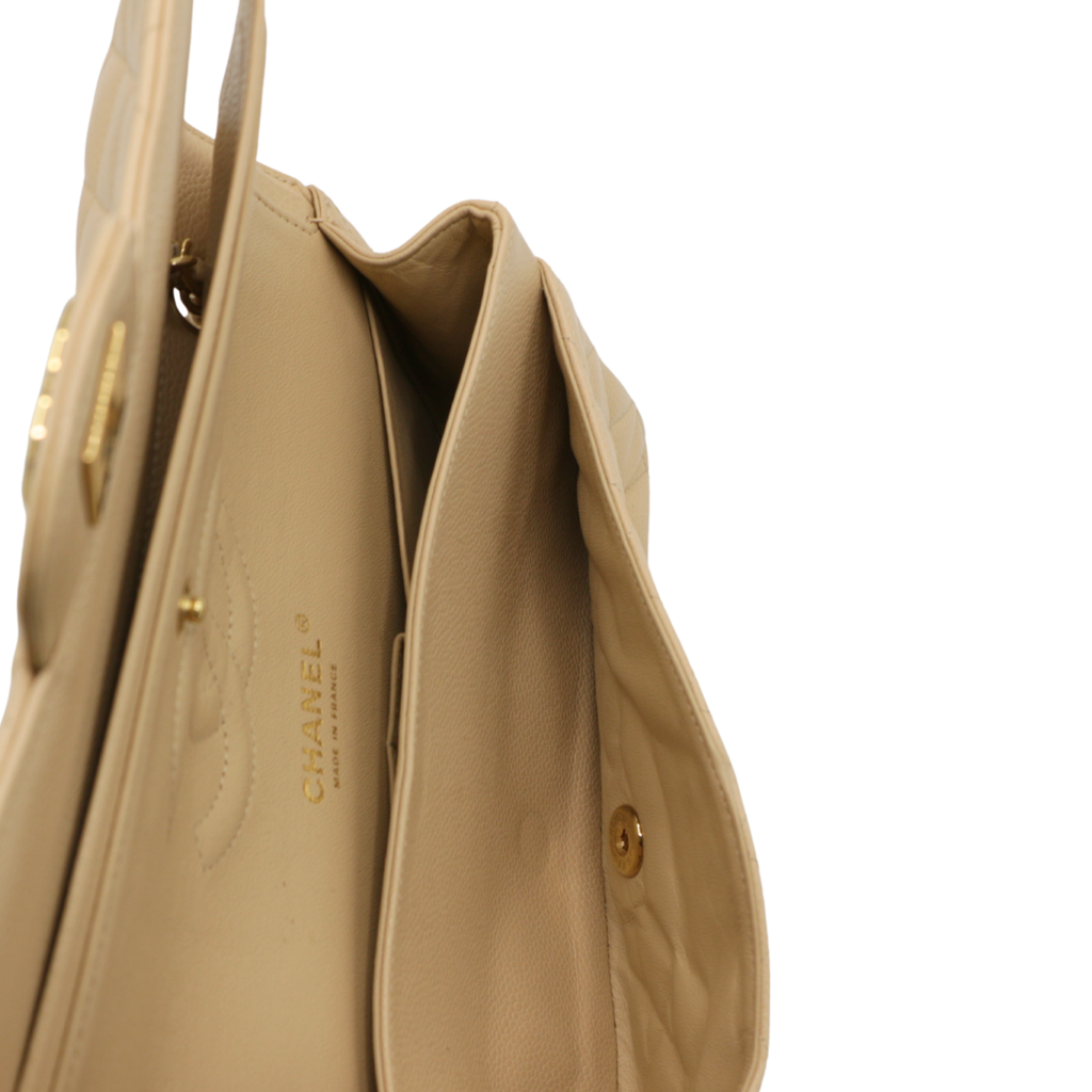Chanel Medium Classic Double Flap bag crafted from caviar leather with beige gold-tone hardware