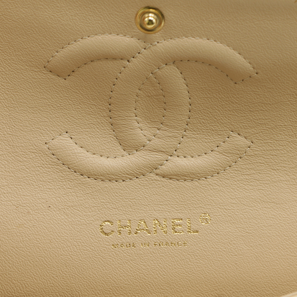 Chanel Medium Classic Double Flap bag crafted from caviar leather with beige gold-tone hardware