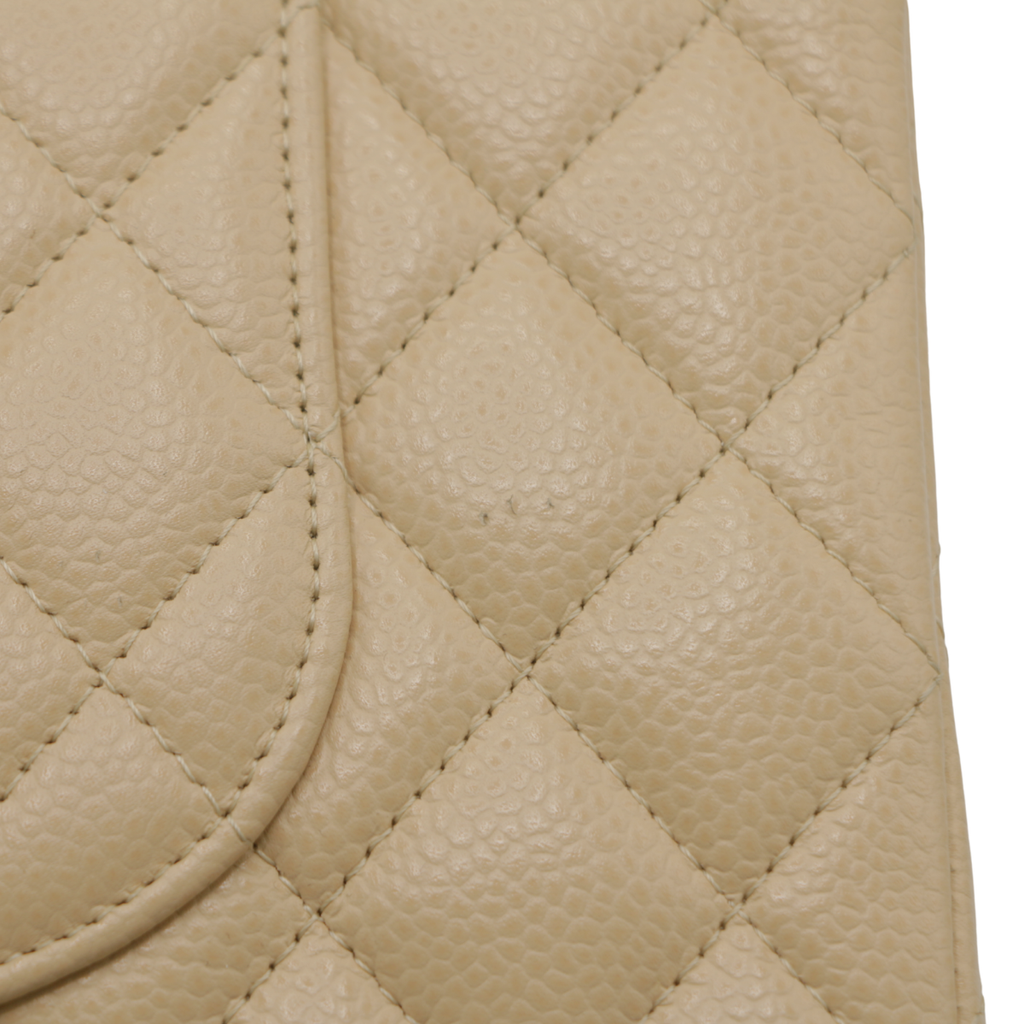 Chanel Medium Classic Double Flap bag crafted from caviar leather with beige gold-tone hardware